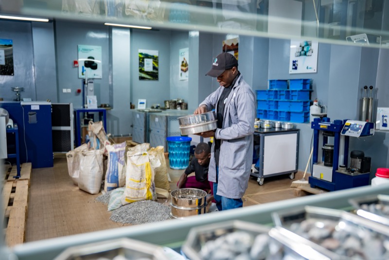 Technician sieving aggregate in the aggregates room