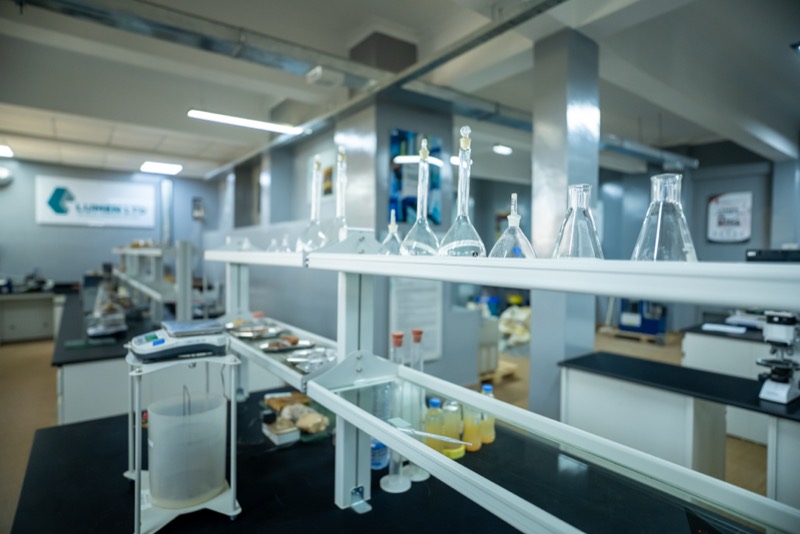 Volumetric flasks and glassware above a laboratory bench