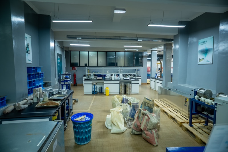 Sample preparation area with core samples, trays and bagged materials